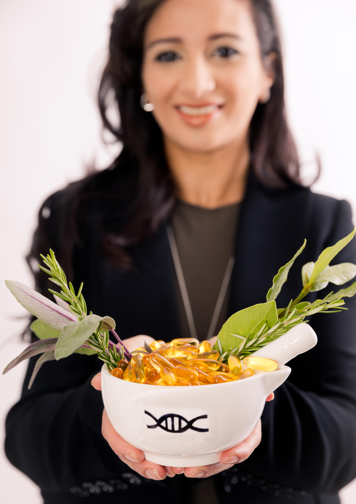 Picture of Australasian Precision Medicine Academy Founder, Katrina Azer, carrying mortar and pestle with DNa strand engraved on it